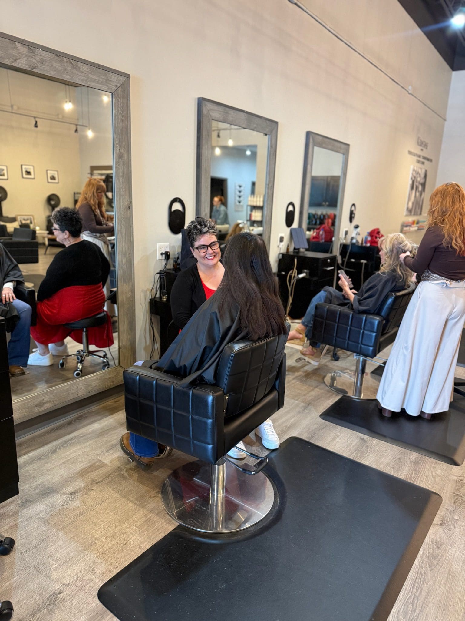 Clients and stylists chatting in salon