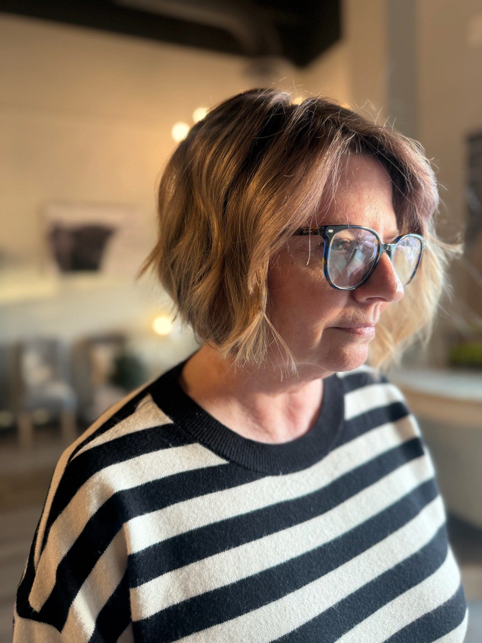 Woman wearing glasses and striped sweater