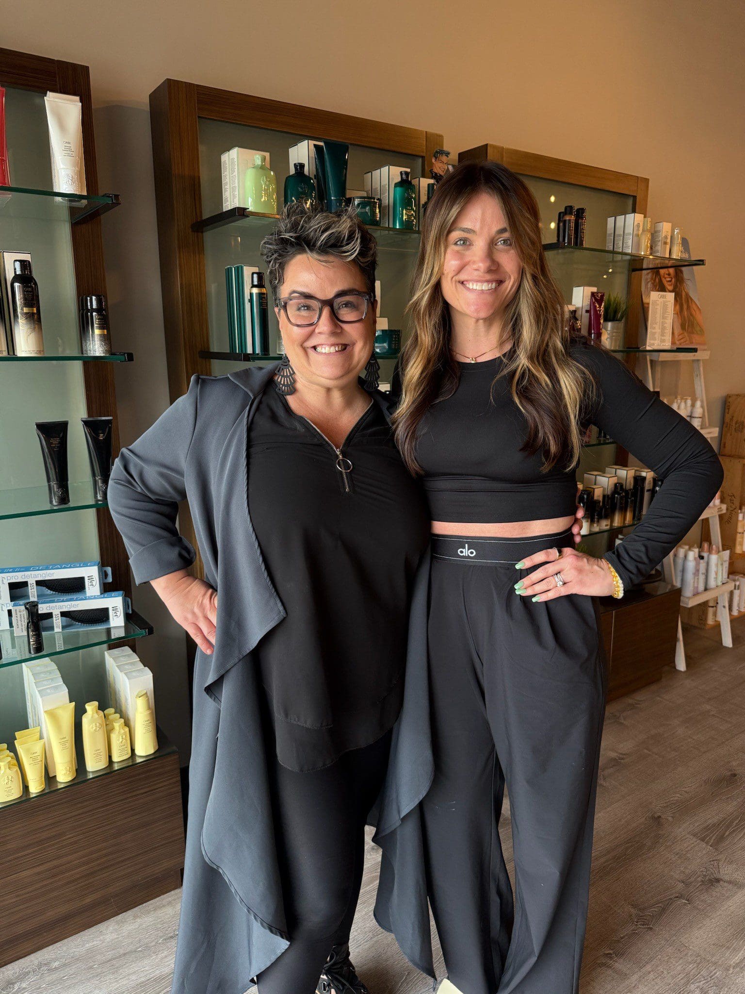 Two smiling women in salon with products