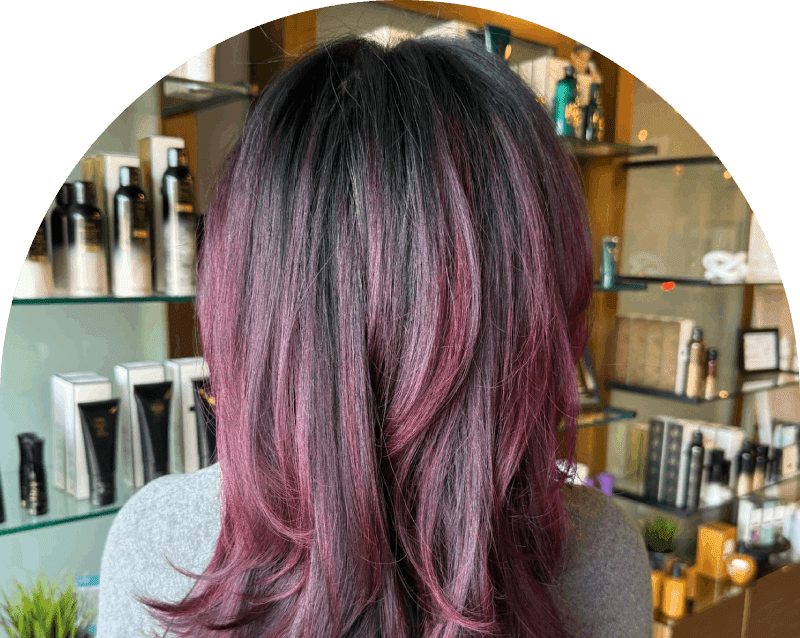 Back view of shoulder-length purple highlighted hair