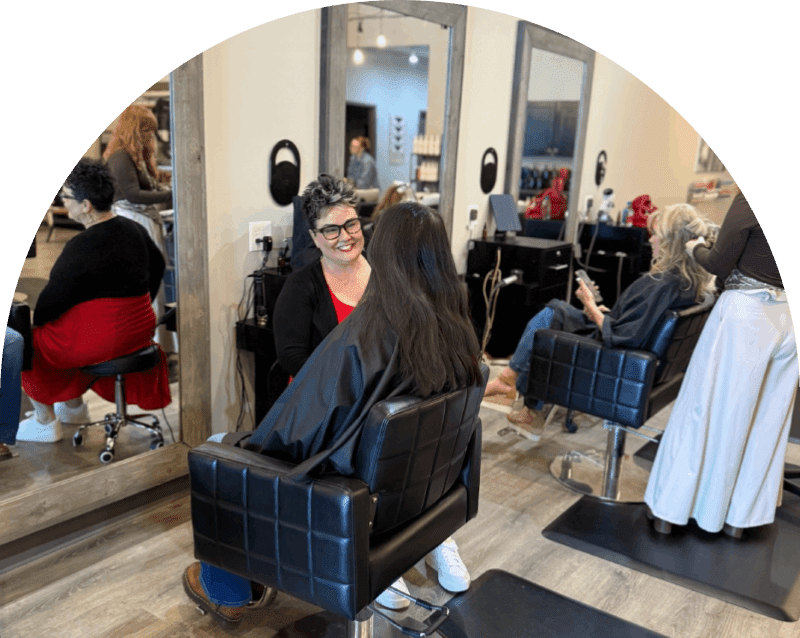 Stylist consulting client in hair salon