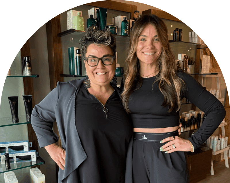 Two smiling women posing in beauty store